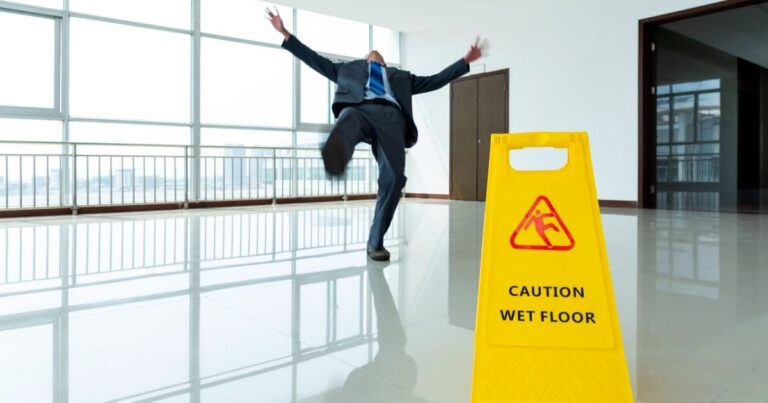 man in suit slipping on floor